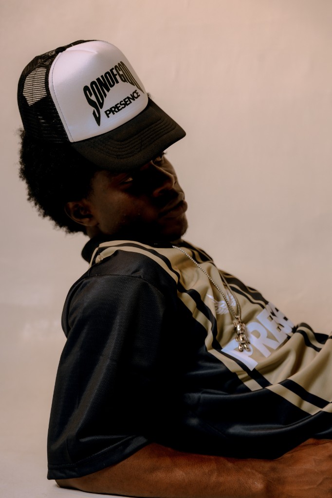 Model in Presence trucker hat and jersey