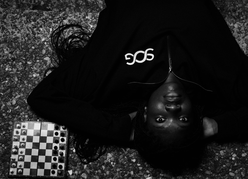 Editorial portrait in SOG quarter-zip on stone pavers