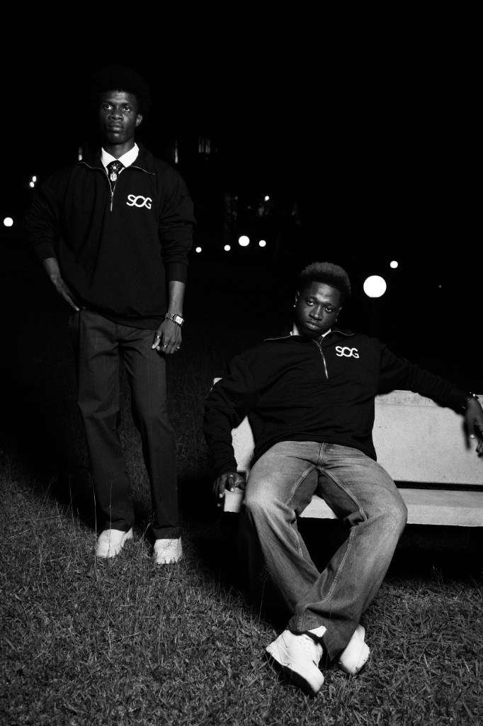 Two models in SOG quarter-zip at night